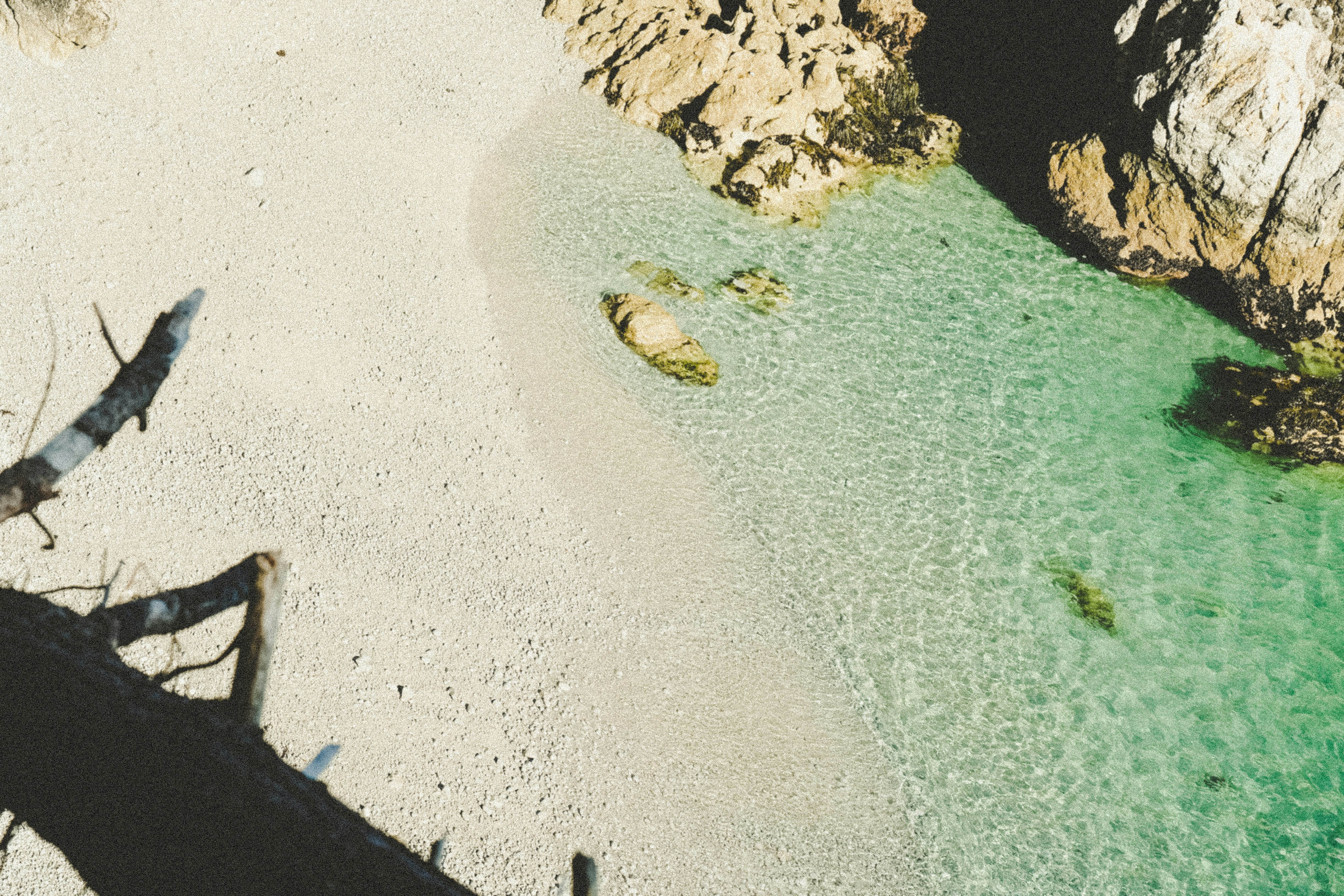 aerial photography of rocks beside body of water